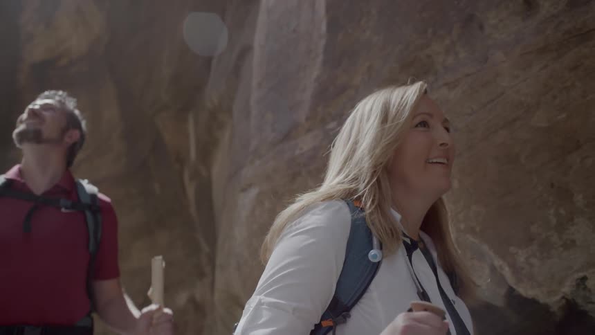 A couple walks through the canyon