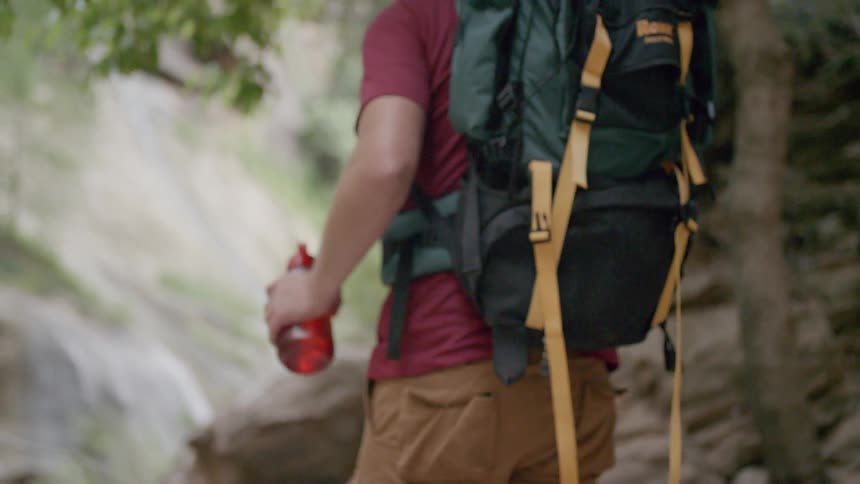 Male hiker hiking on rocks in a canyon
