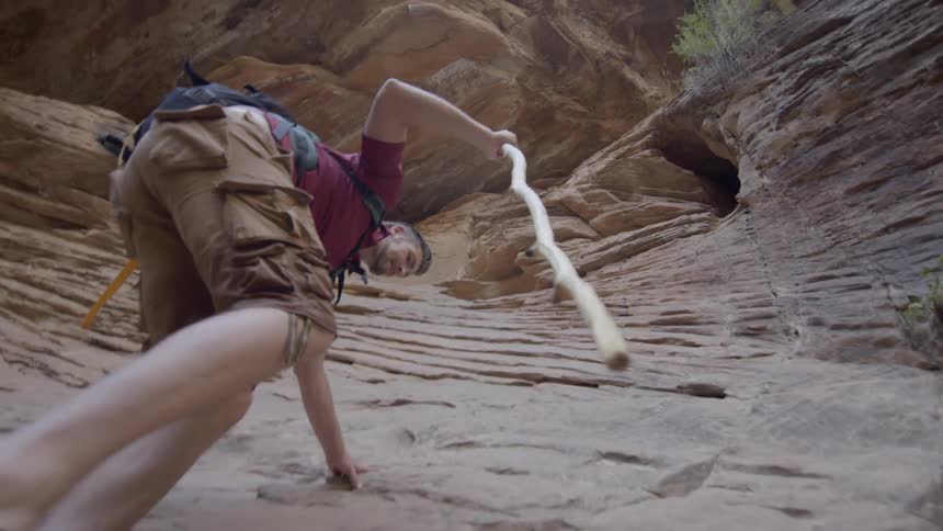 A man hikes up the rock formation