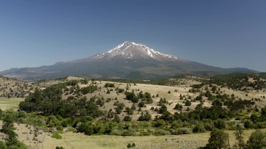 Landscape view of tree covered hills with a mountain in the back