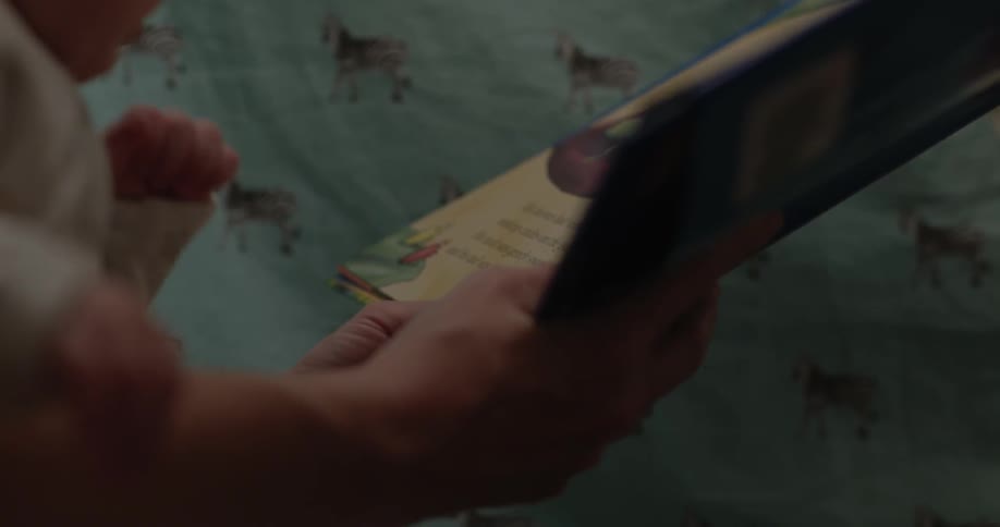 A book is read to a baby