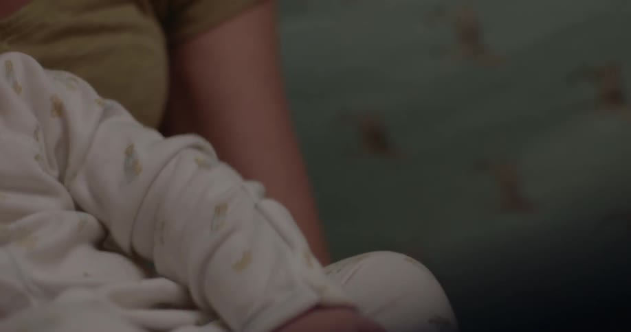 A woman holds a baby on her lap