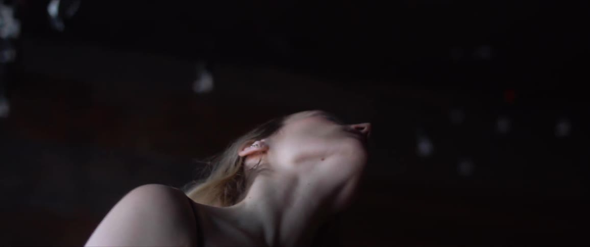 Blonde woman rotates her neck on her shoulders