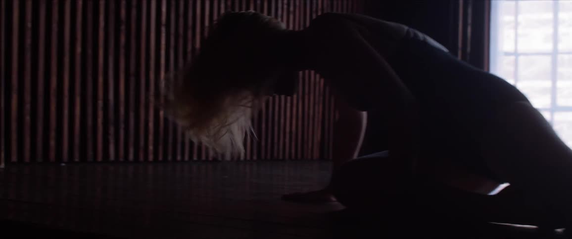 A woman is dancing and falls