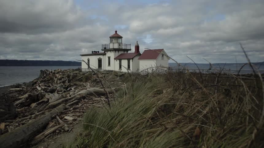 A white building on the edge of the coast