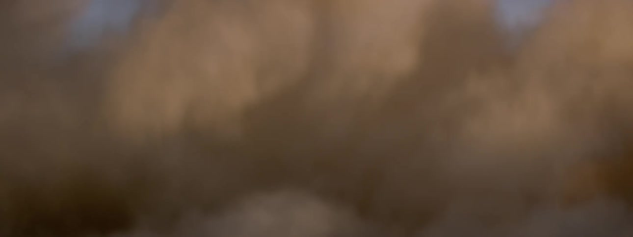 The tires of a black suv approach quickly creating a heavy dust cloud