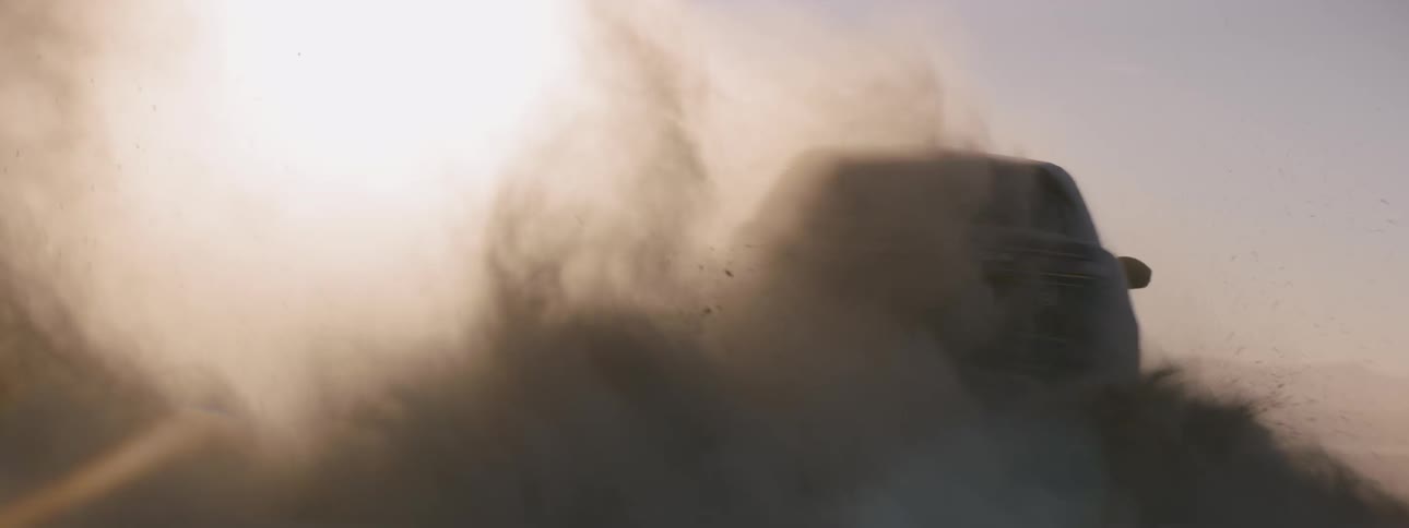 A vehicle circling a parked car in the dirt
