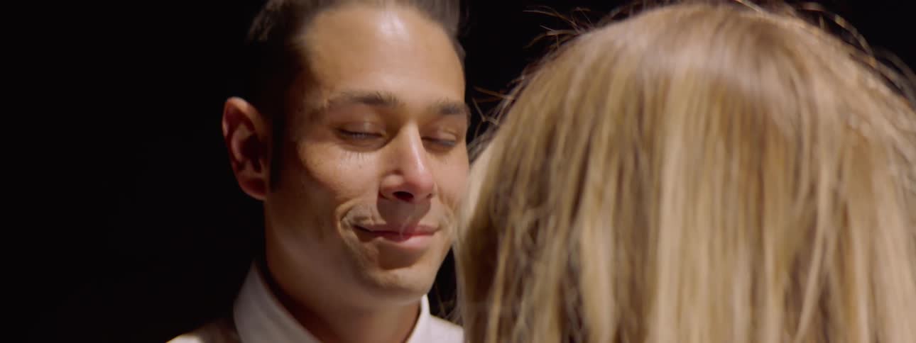 A man and woman are looking at each other
