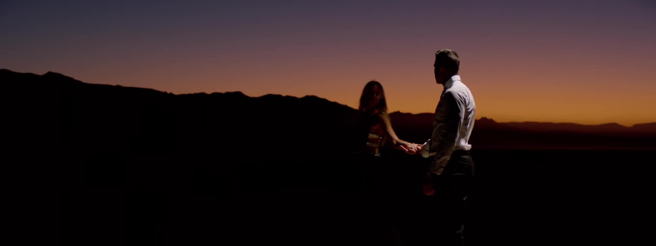 A couple start to dance in a remote romantic setting at dusk