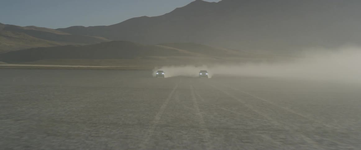 The two cars race in the desert