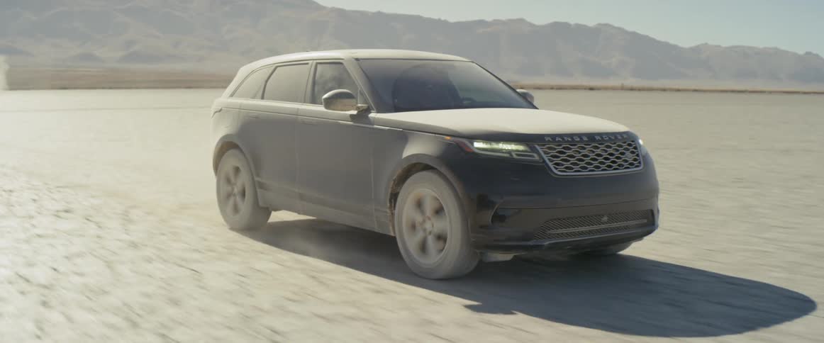 A dirty vehicle is driving over the desert