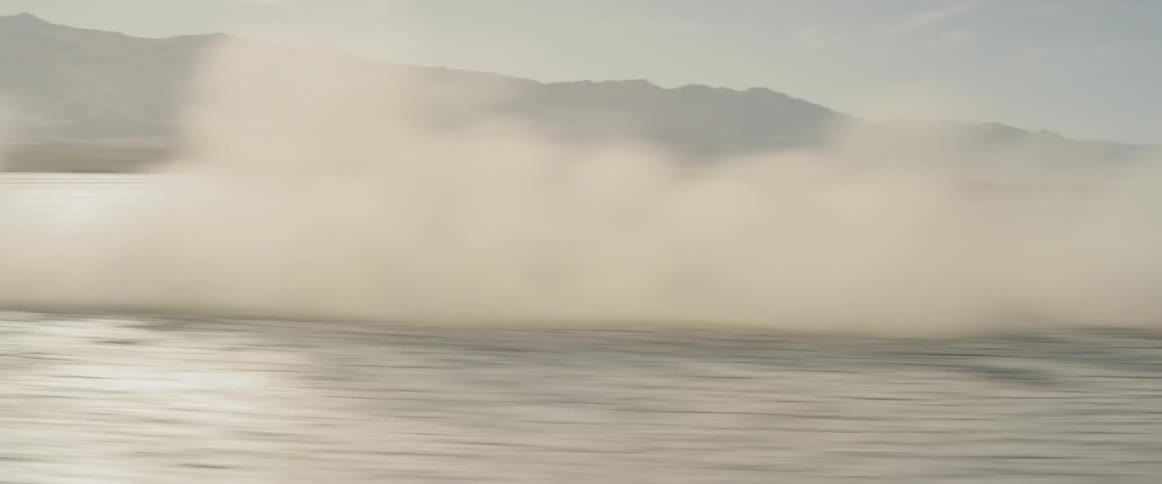 A black range rover sport driving across the salt flats