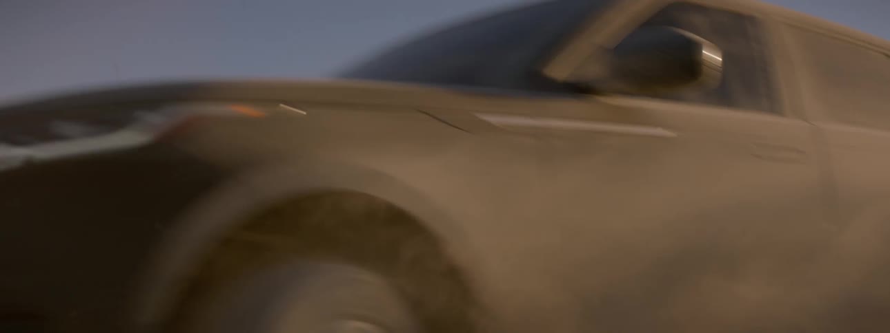 Close up shot of a black range rover sport driving across the salt flats