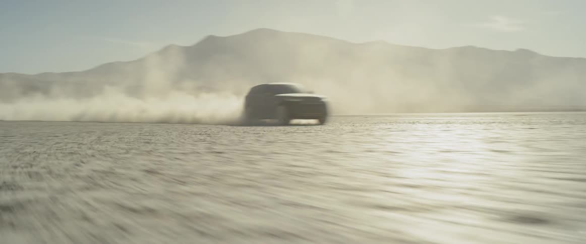 A car races across the desert