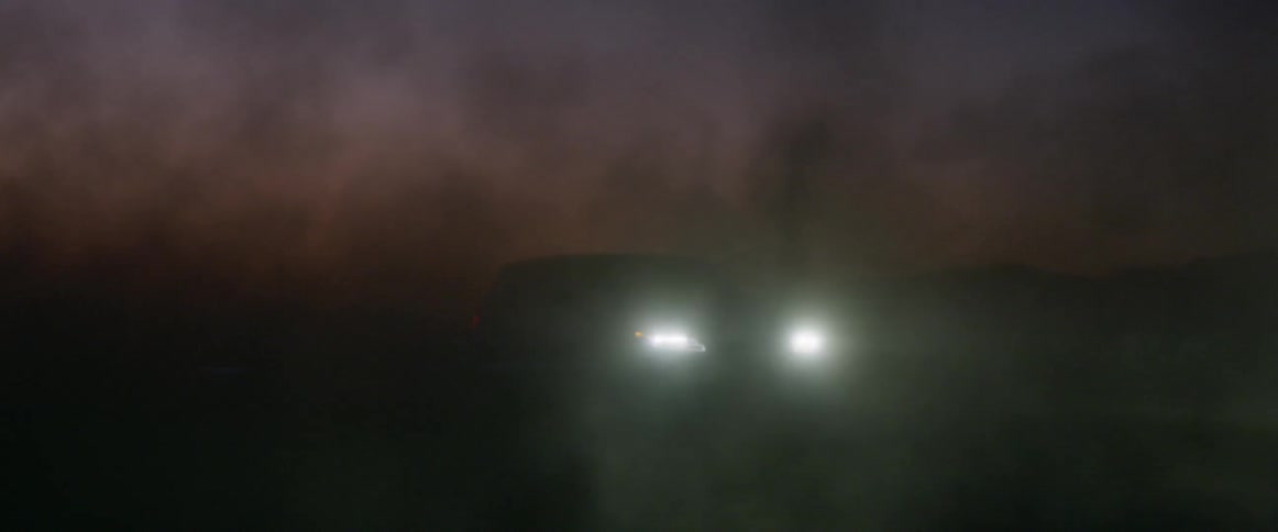 Cars circling around each other in desert at sunset