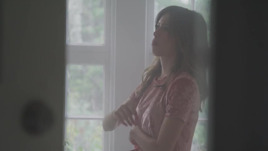 A woman seems upset in the bedroom