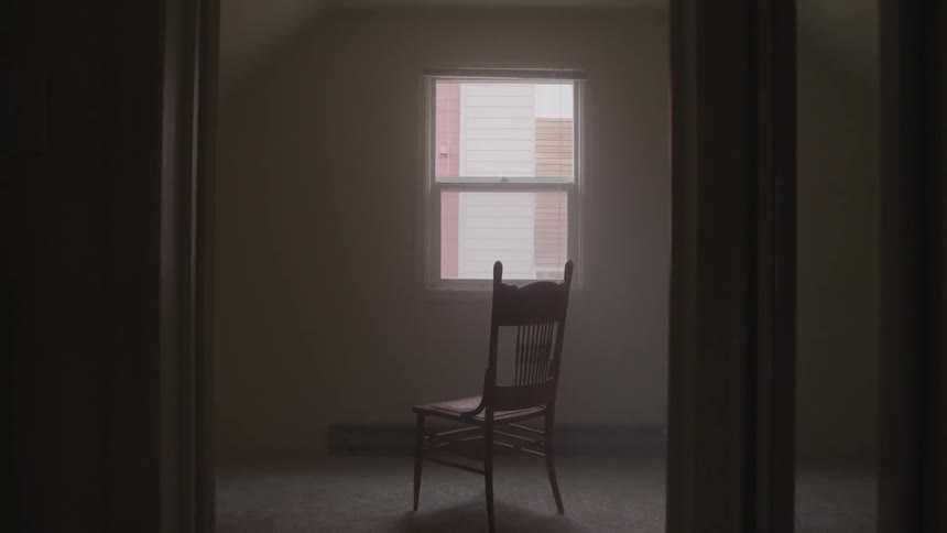 An empty chair sits in a room