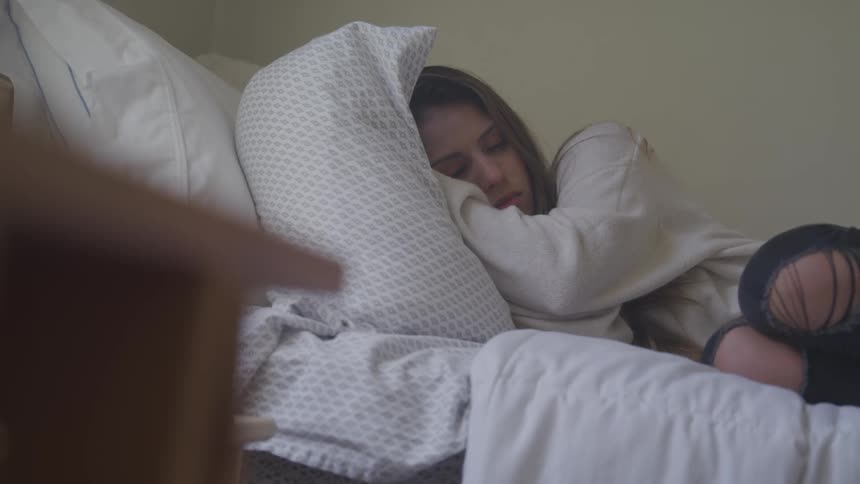 A white teenage girl sleeping in a bed