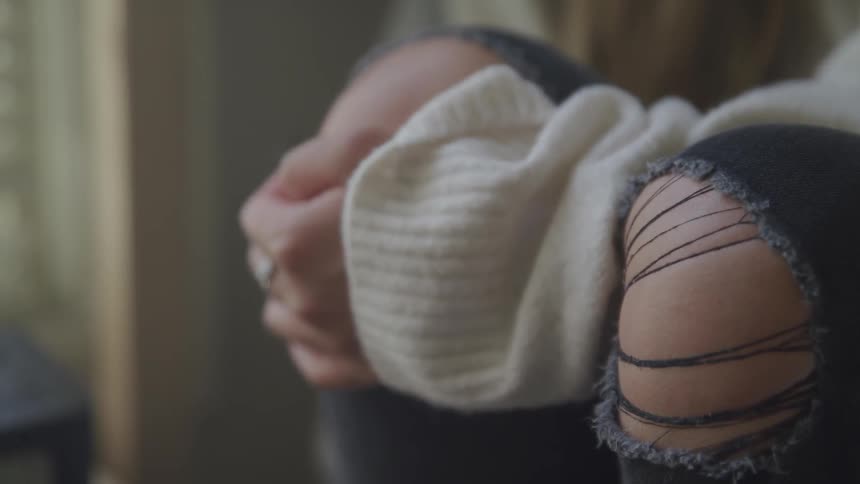A woman holding her hands together