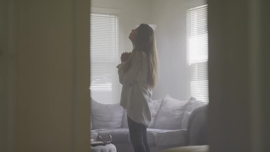A woman prays in the room