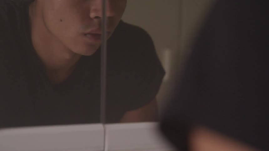 A person inside looking into a mirror