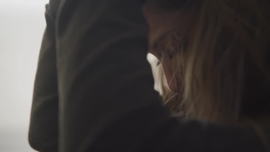A woman despairingly puts her head in her hands