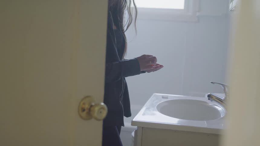 A woman is taking her medication