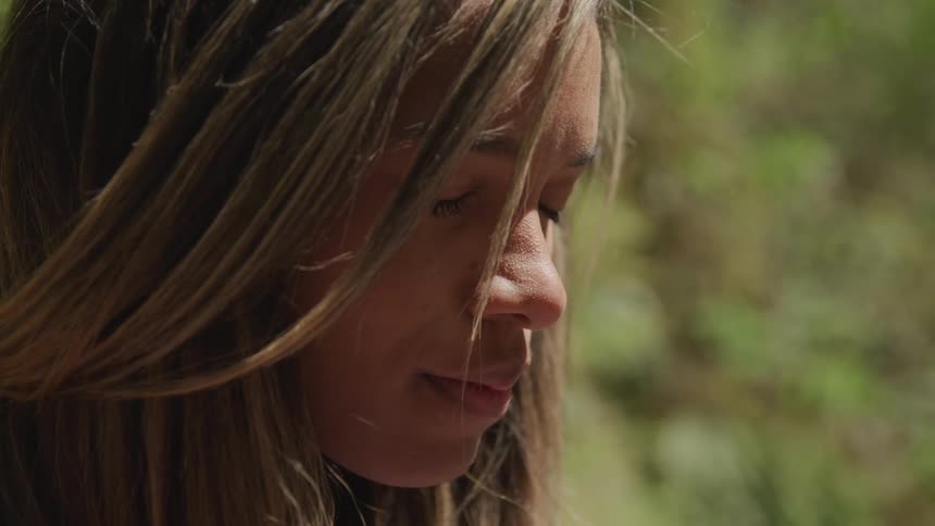 A woman has her eyes closed