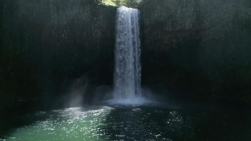 A scenery of a waterfall surrounded by rock
