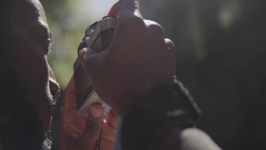 Man raising camera to face and takes a picture