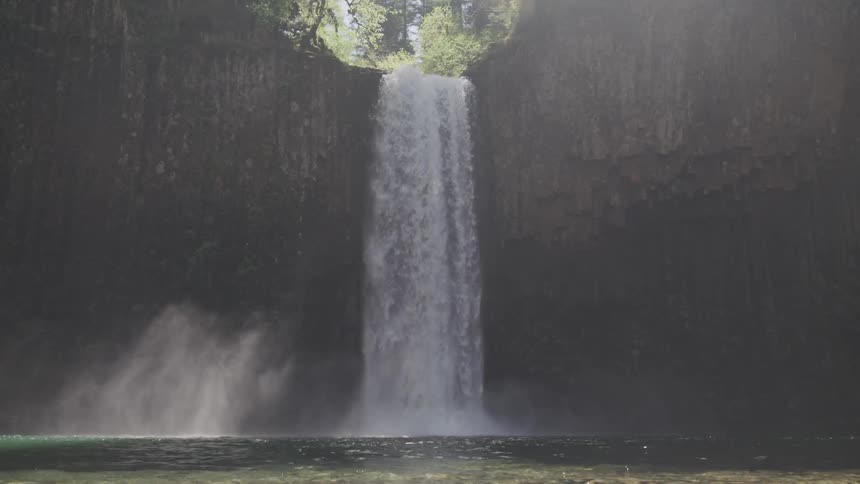 A waterfall crashes over the edge of a cliff