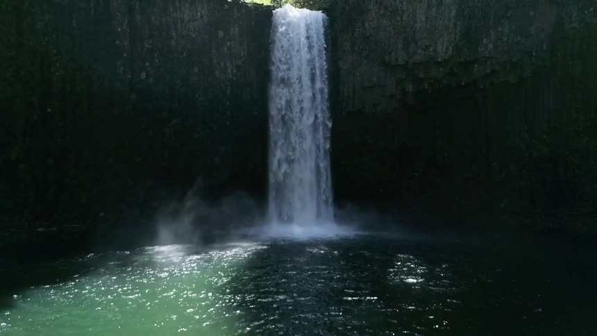 The waterfall is slowly pouring into the spring