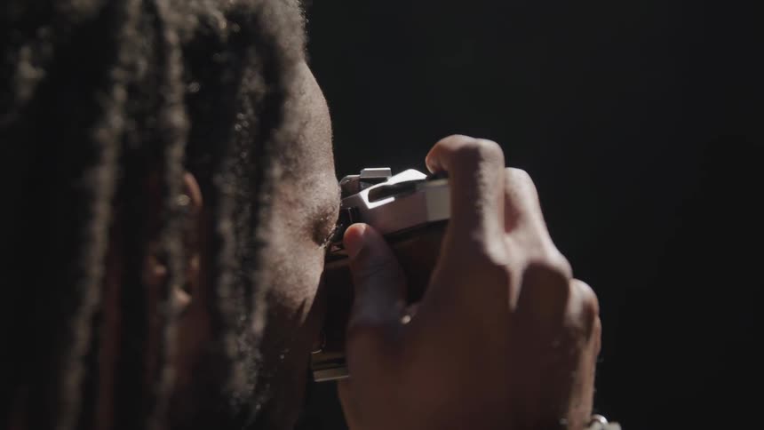 A man lifts a camera to take a photo