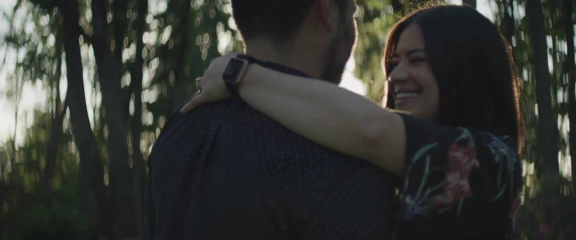 A couple hugging on the park at dawn