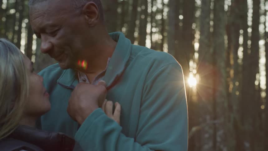 A man and a woman dancing in the woods