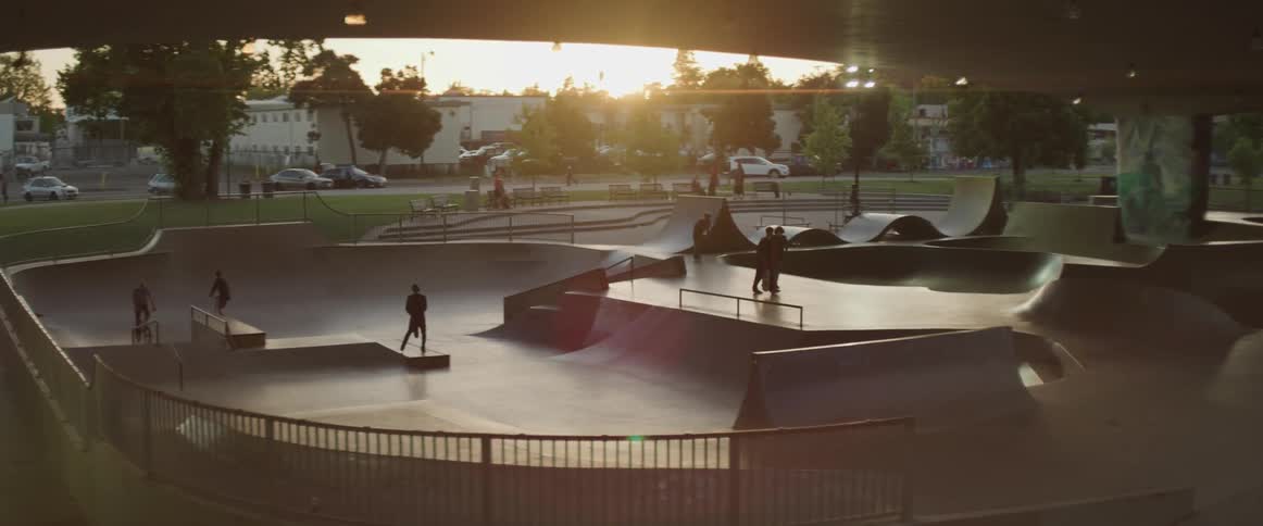 People ride bikes and skate boards at an outdoor area