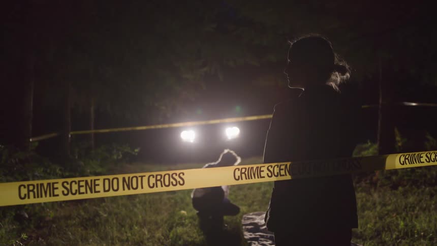 Police investigate at a cordoned off crime scene