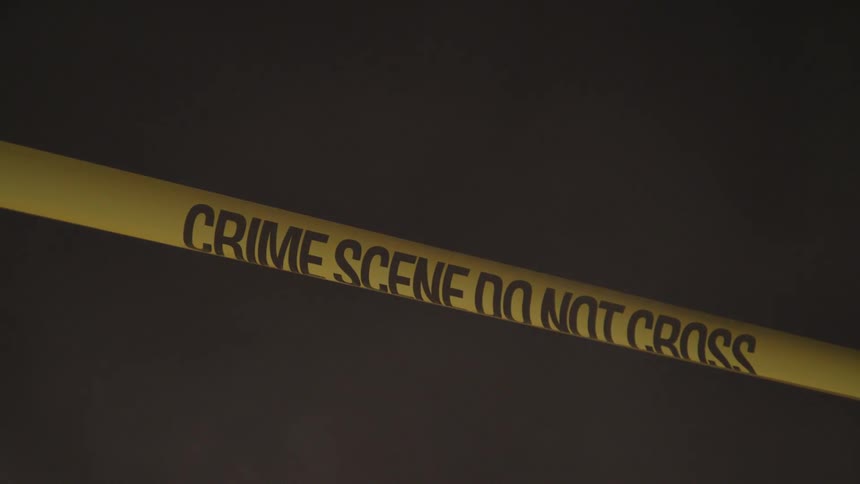 A crime scene tape is surrounded by fog