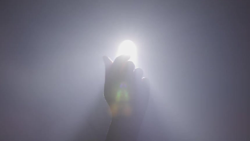 A person holding a hand in front of a light