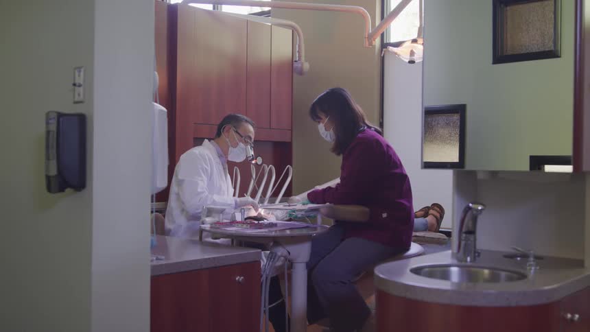 A doctor and nurse work on a patient