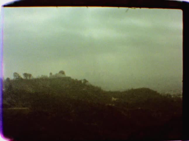 View of a hill with trees on an overcast day