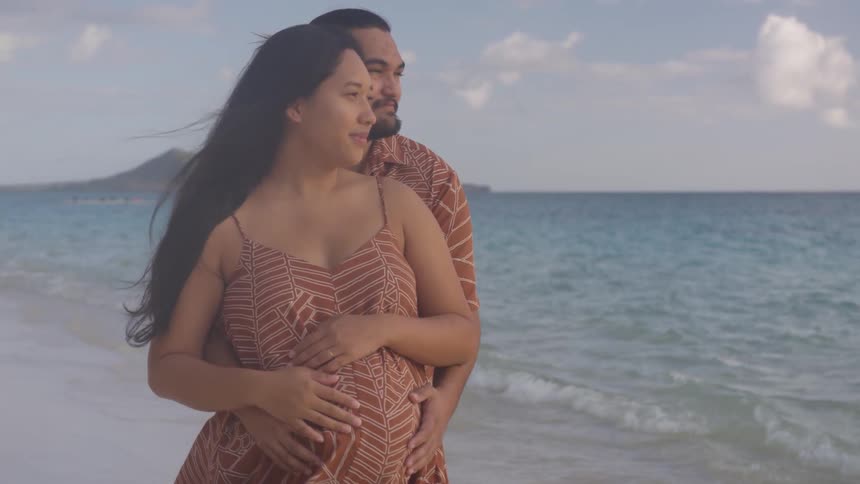 A man and a woman standing on a beach