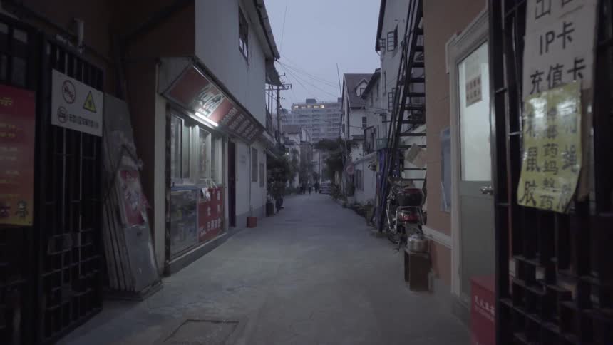 An empty narrow street in an asian country at night