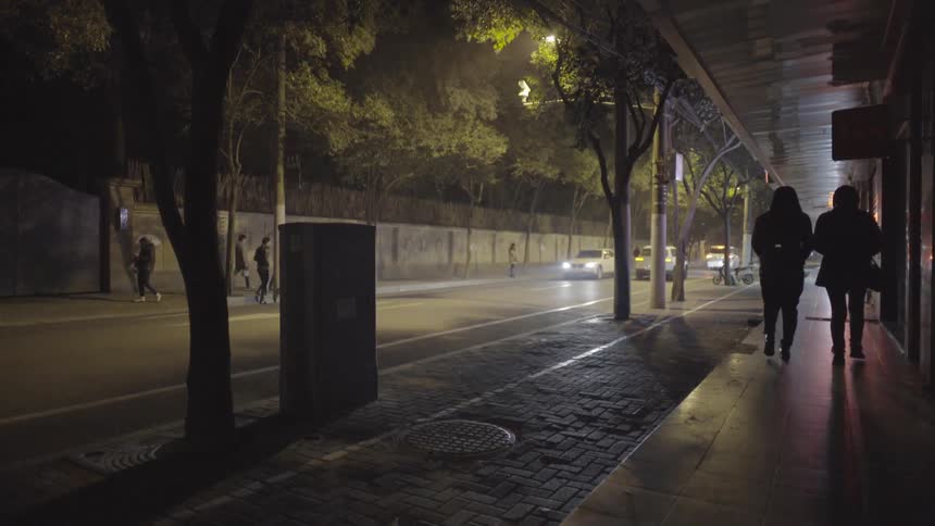 A busy sidewalk at night