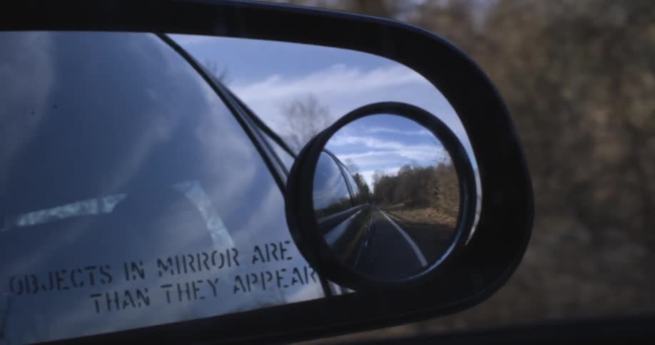 A view from the rear view mirror of a car