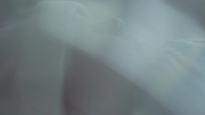 Baby sleeps under blanket indoors