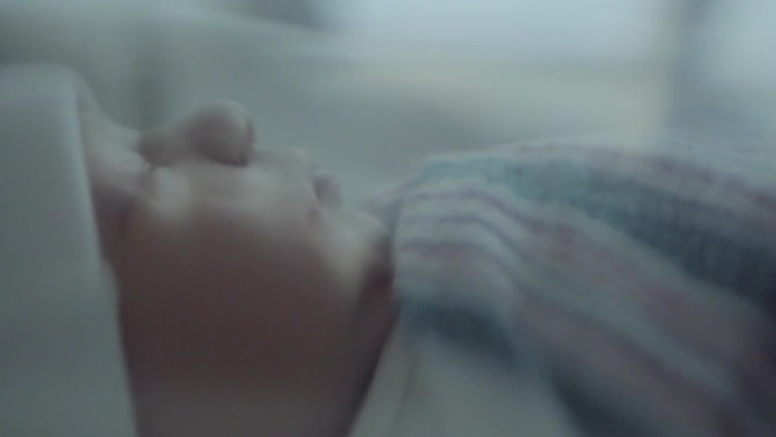 A sleeping baby on a bed