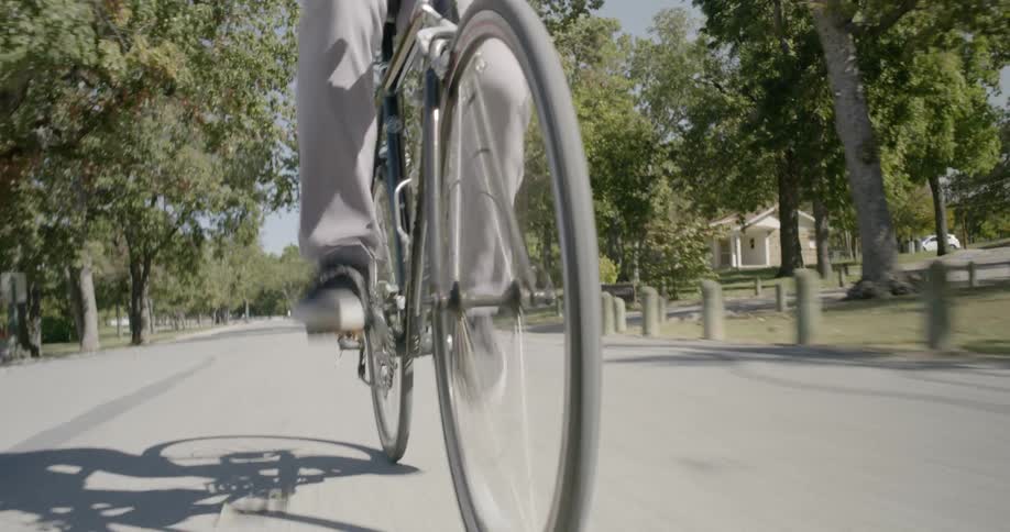 A man rides his bike down a street
