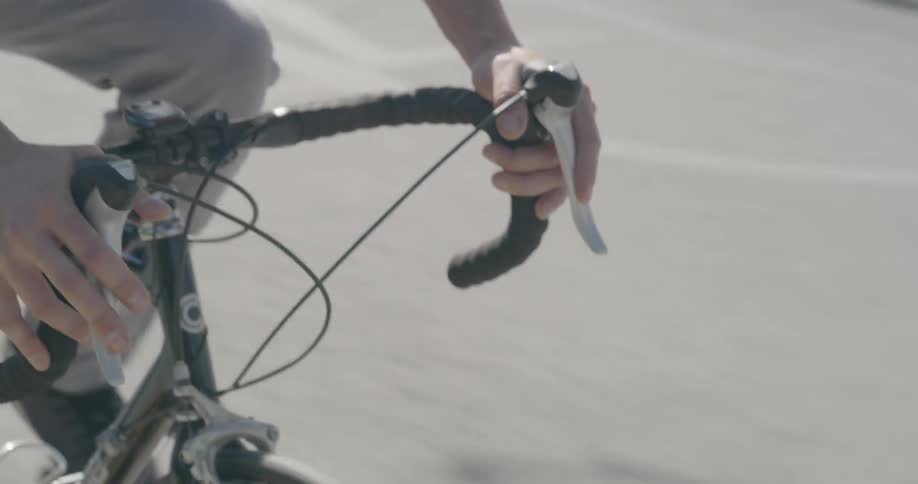 A man hands and legs as he is riding a sports bike