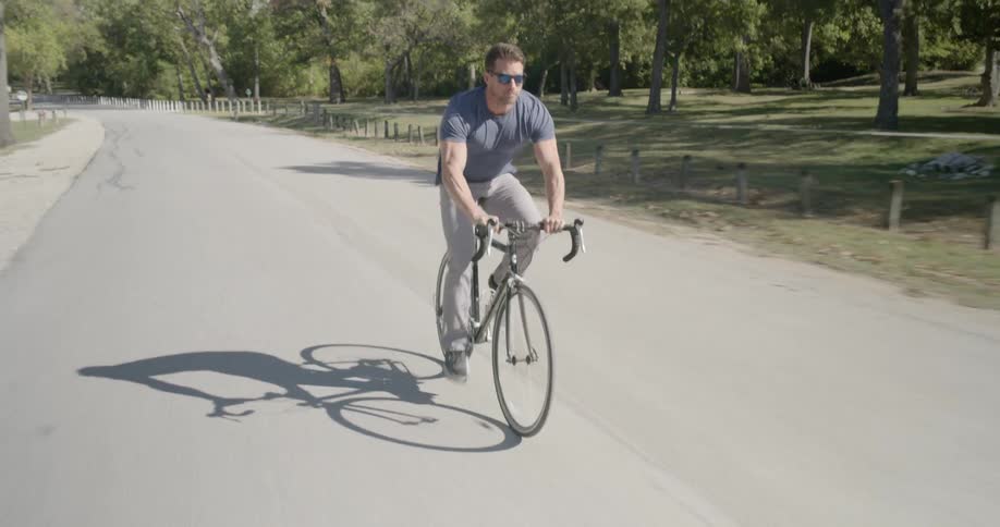 A man riding a bicycle on a sunny day